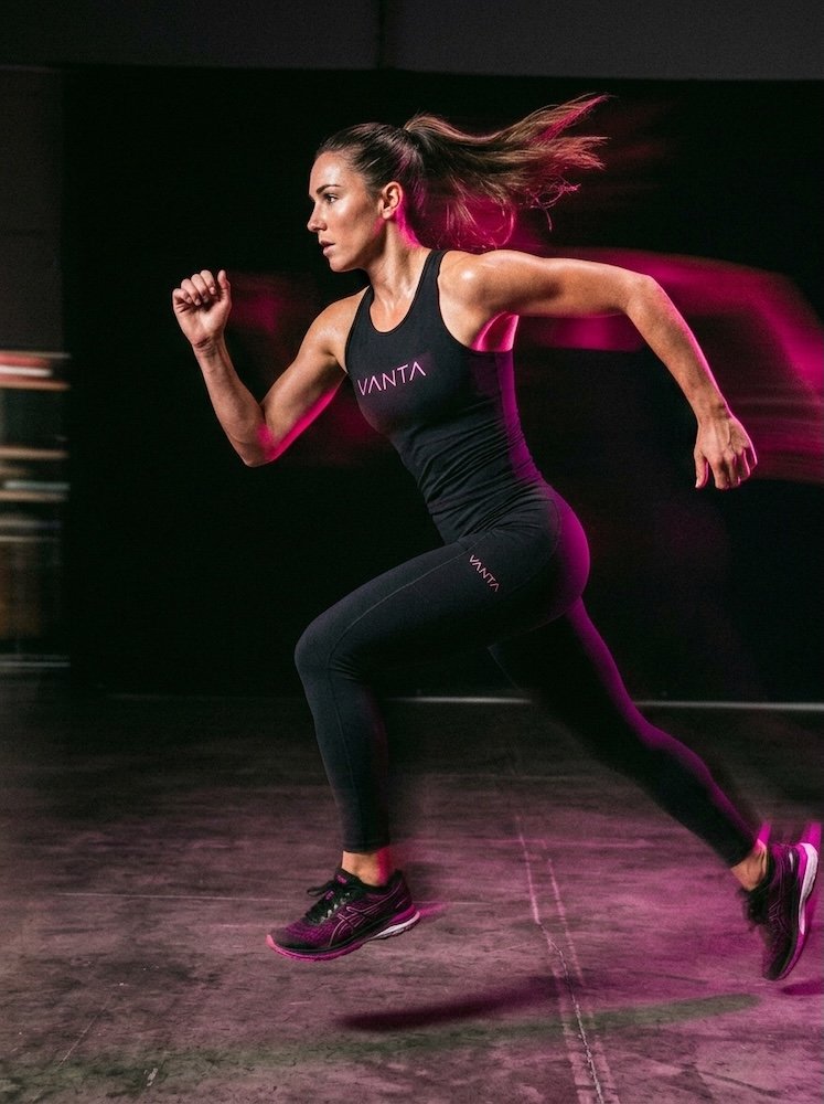 VANTA performance apparel worn on a figure in motion, duotone void and magenta.
